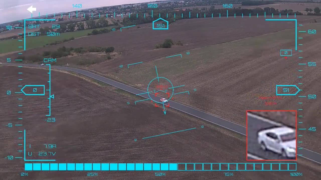 White sedan at a junction — onboard AI target lock and real-time tracking from a UAV, FPV goggles DVR